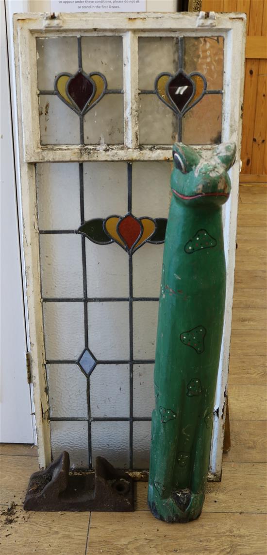 A stained glass window, gypsy folk art frog and railway rivet W.51cm